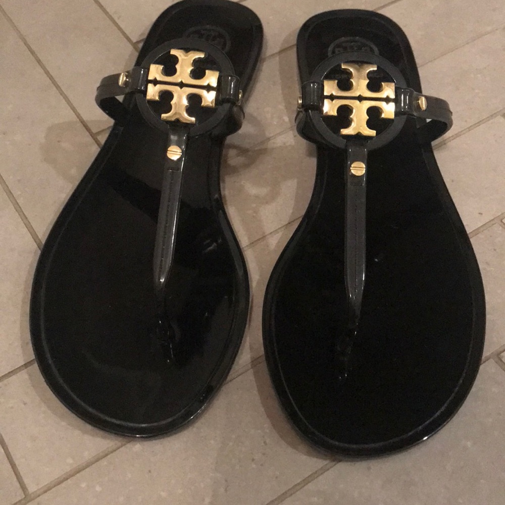 Tory Burch rubber flip flops . Black w gold .